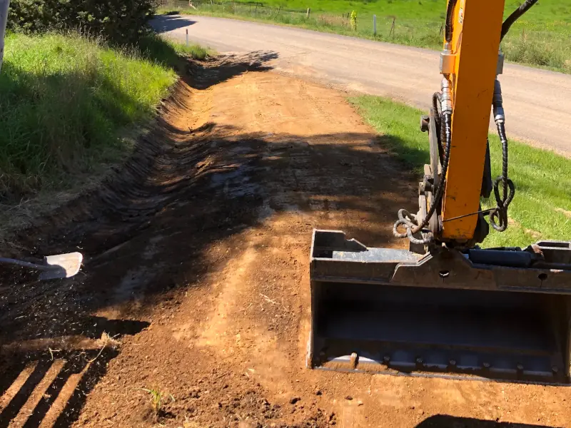 Excavation contractor excavating earth.